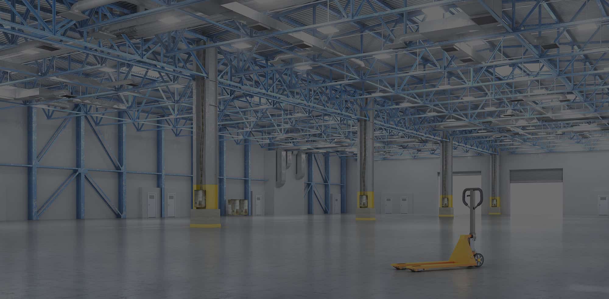 Large empty warehouse with yellow pallet jack