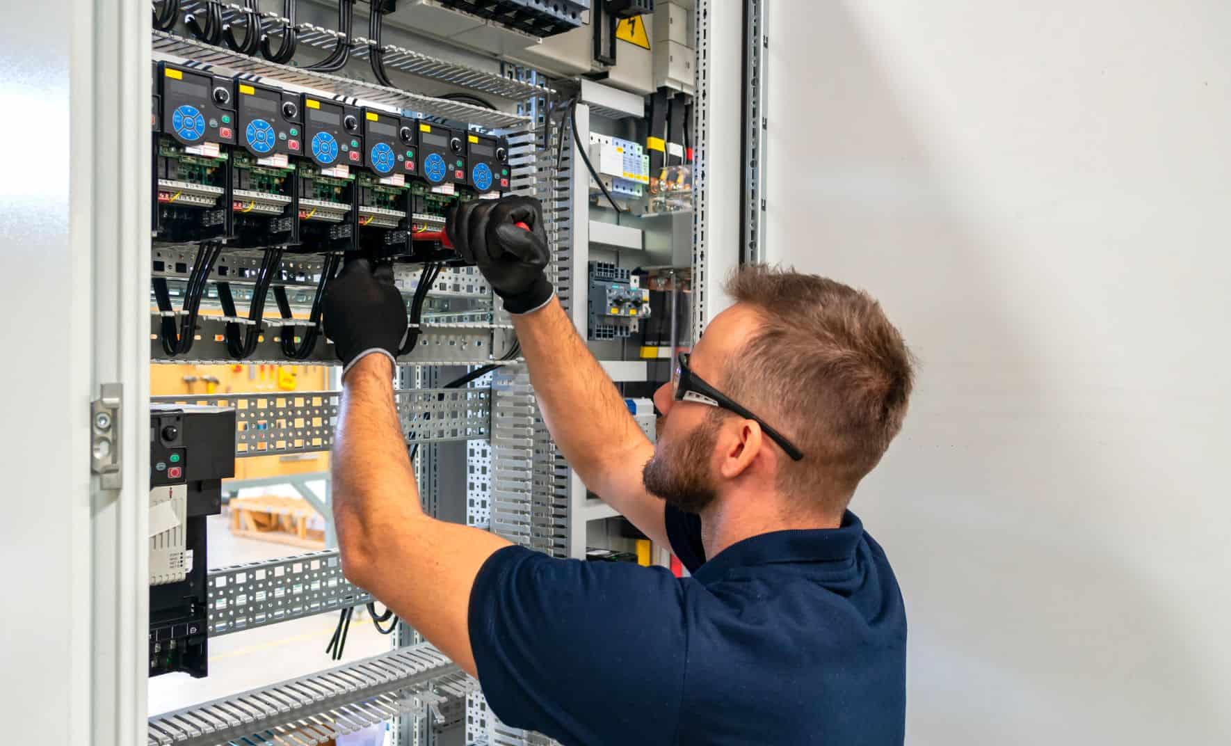 Electrician working on a control panel