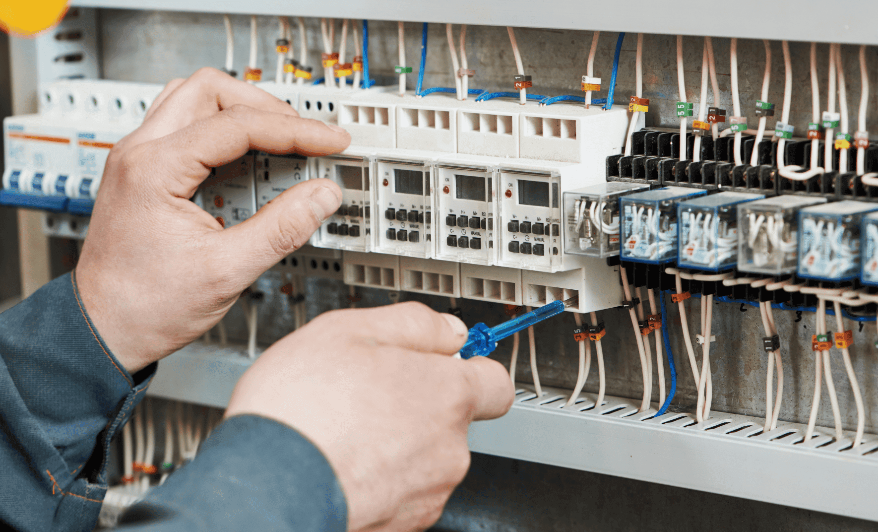 Electrician working on circuit breaker panel