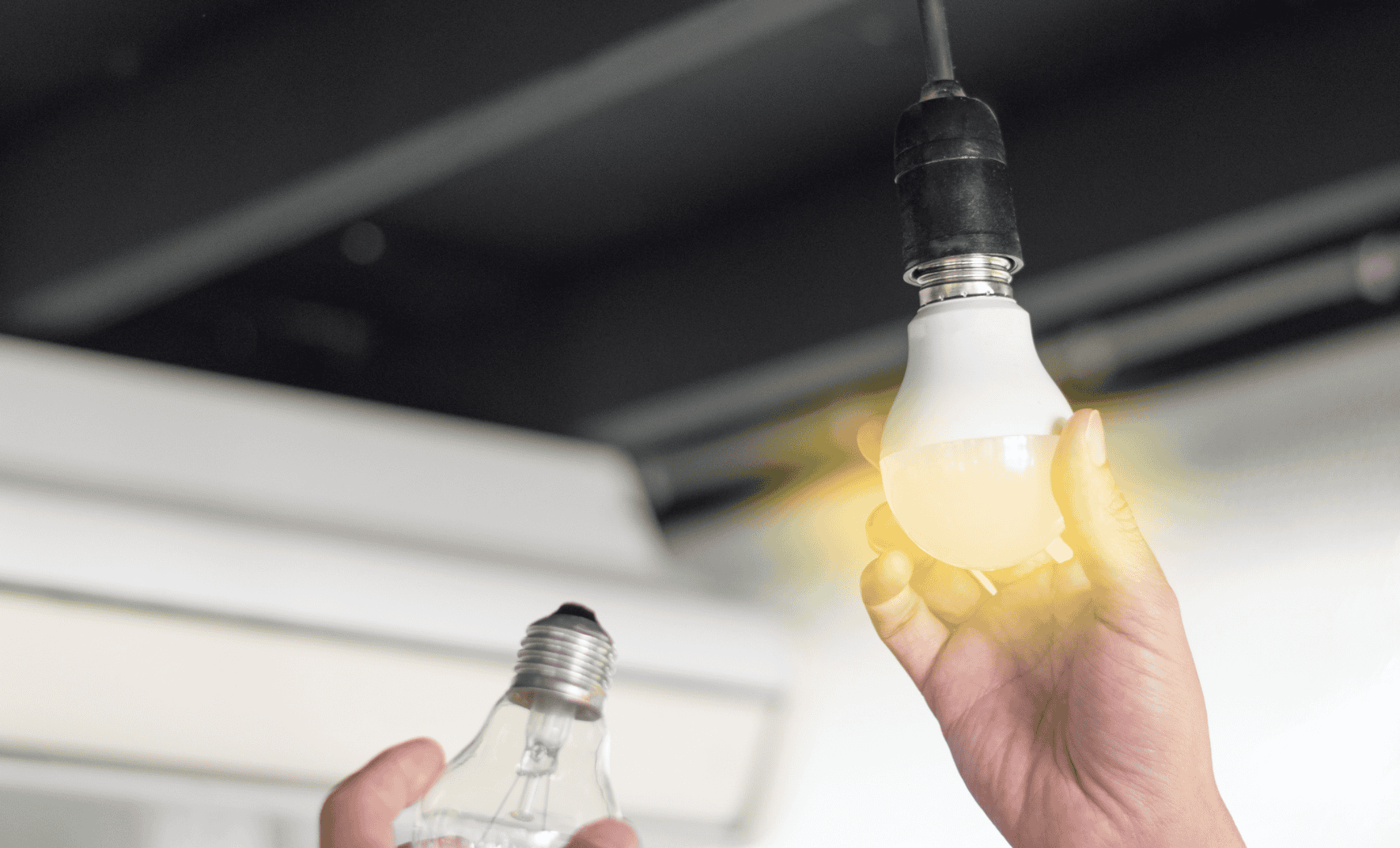 Hand installing an LED light bulb